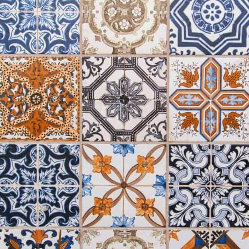 Colorful ceramic tiles with intricate Mediterranean and Spanish-inspired patterns, ideal for interior and exterior design projects, showcasing vibrant blues, oranges, and earthy tones.