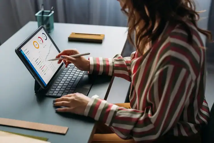 Data analysis on a tablet at a designer charrette, focusing on modern collaboration and creative design insights for architectural and interior design projects.