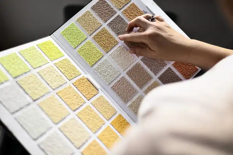 Color swatch sample book with various shades of yellow, beige, and brown for interior design and decor inspiration.